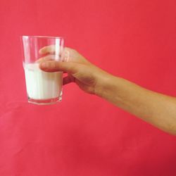 Close-up of hand drinking glass
