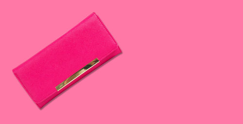 Close-up of pink pencils against colored background
