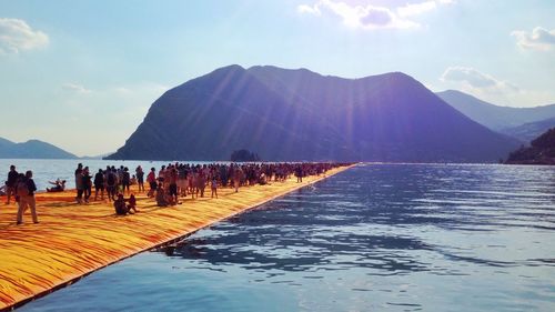 Scenic view of calm sea against mountain range