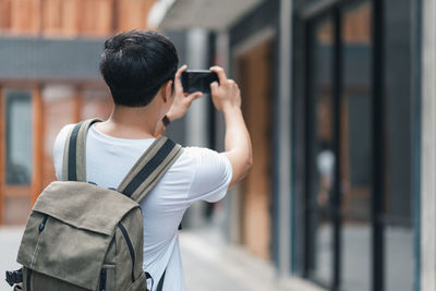 Rear view of person photographing