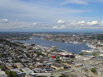 High angle view of cityscape and river against sky