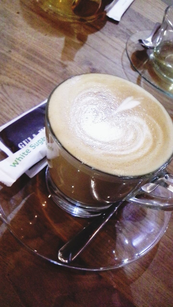 drink, indoors, food and drink, refreshment, table, still life, coffee - drink, coffee cup, freshness, saucer, frothy drink, close-up, high angle view, spoon, drinking glass, cappuccino, coffee, froth art, wood - material, no people