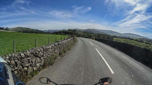 Empty road with mountains in background