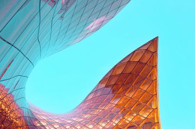 Low angle view of skyscraper against blue sky