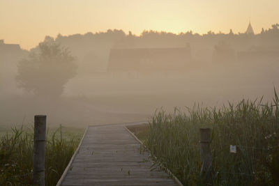 View of boardwalk during sunrise