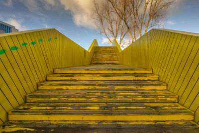 Low angle view of empty staircase against sky