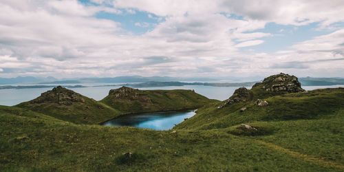 Scenic view of sea and mountains against sky