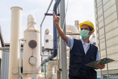 Portrait of man standing in factory