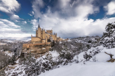 Buildings against cloudy sky during winter