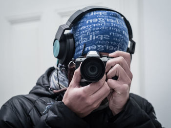 Portrait of man photographing with camera