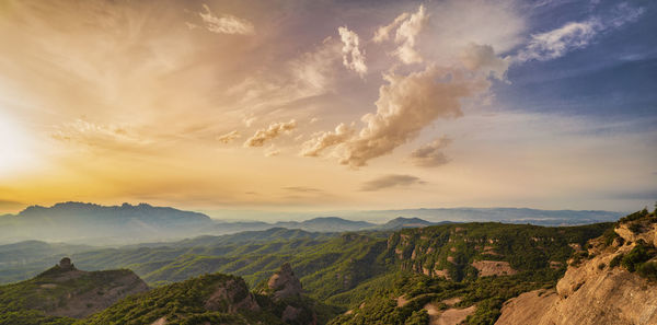 Scenic view of mountains against cloudy sky