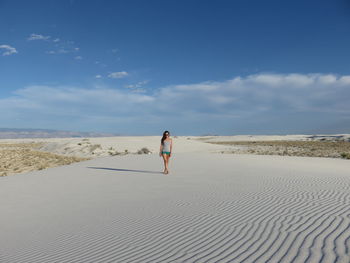 Full length of woman standing on beach