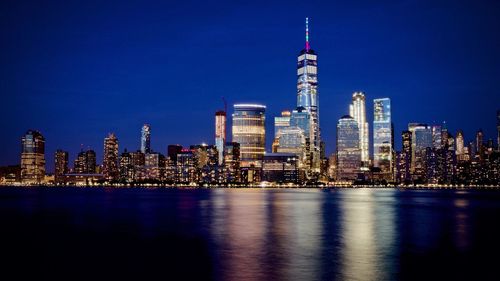 Illuminated city at waterfront