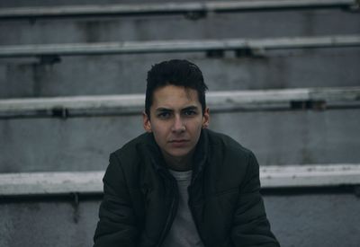 Portrait of young man sitting on steps