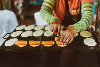 Close-up of woman preparing food on table