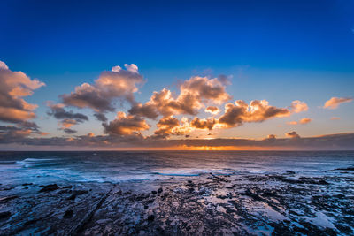 Scenic view of sea against sky at sunset