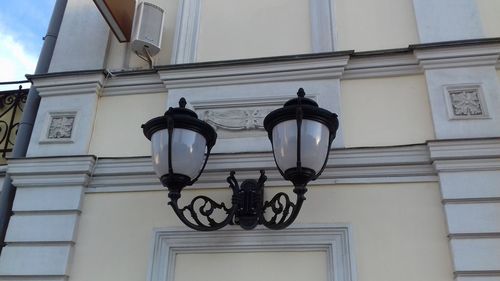 Low angle view of street light against building