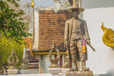 Statue outside temple against building