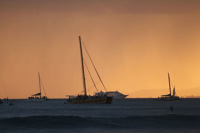 Sailboat sailing on sea against sky during sunset