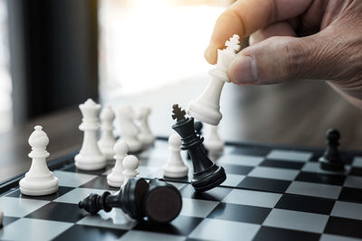 Close-up of hand playing chess