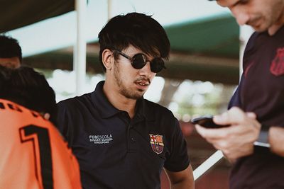 Portrait of young man wearing sunglasses standing outdoors