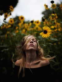 Portrait of woman with yellow flowers