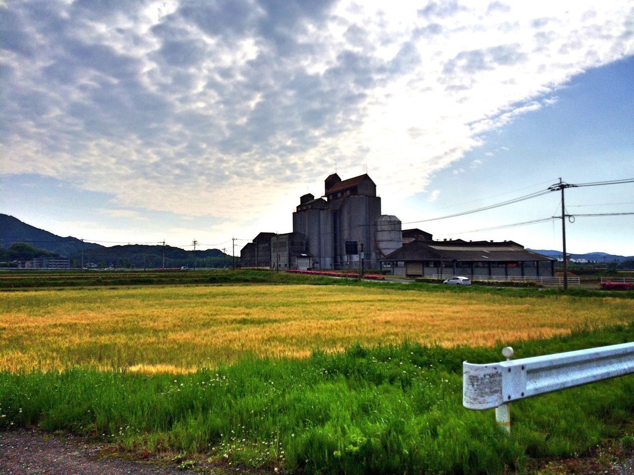 grass, architecture, building exterior, built structure, sky, field, cloud - sky, landscape, grassy, cloud, rural scene, house, nature, cloudy, no people, tranquil scene, beauty in nature, tranquility, day, green color