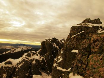 Scenic view of rocky mountains against sky during winter