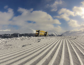 Snow covered land against sky