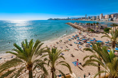 Tourists in benidorm mal pas beach. spanish resort city in  mediterranean sea. 