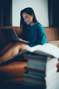 Young woman sitting on book