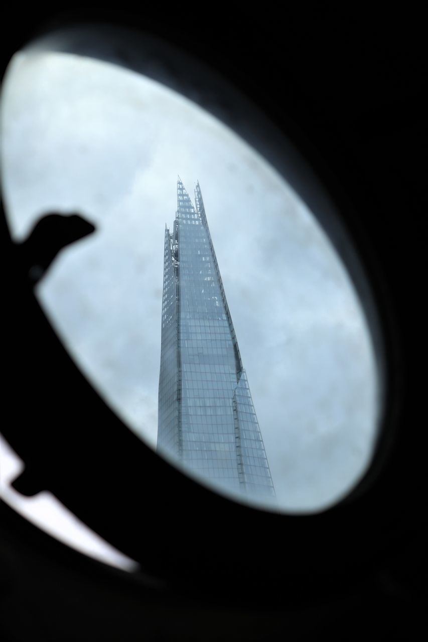 CLOSE-UP OF MODERN BUILDINGS AGAINST SKY
