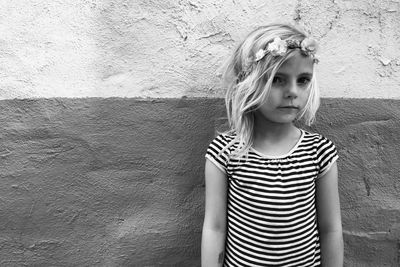 Portrait of cute girl wearing tiara against wall