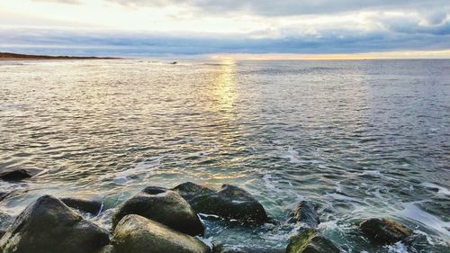 Scenic view of sea against cloudy sky