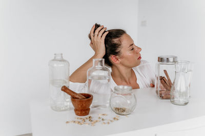 Portrait of a young girl on a white background at the table