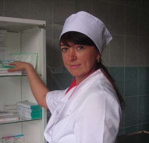 Side view portrait of smiling nurse working in medical clinic