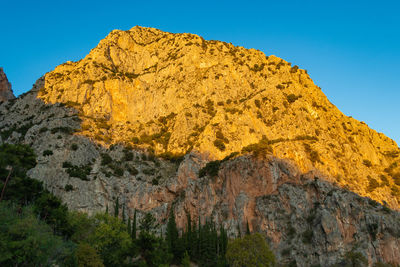 Low angle view of rock formation against sky