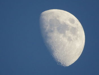 Low angle view of moon against blue sky