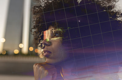 Thoughtful afro woman wearing smart glasses