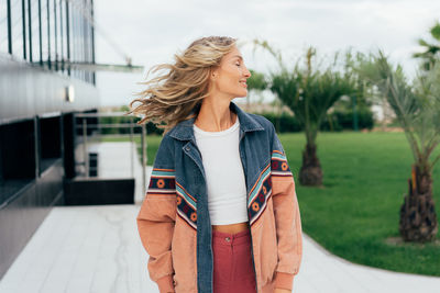 Portrait of woman with blowing blond hair.