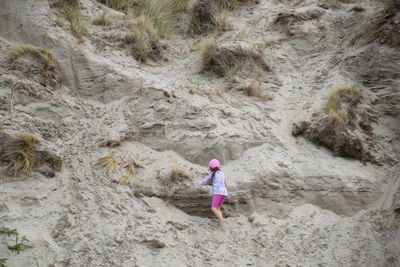 Rear view of girl climbing on mountain