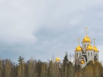 Low angle view of church against cloudy sky