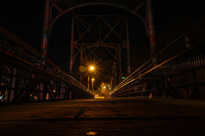 Illuminated bridge at night