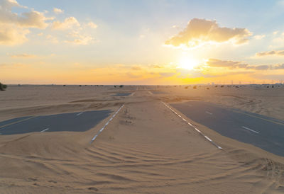 Scenic view of beach against sky during sunset