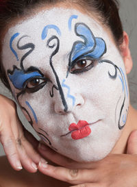 Close-up of woman with face paint at home during halloween