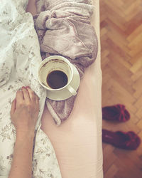 Midsection of woman holding coffee cup