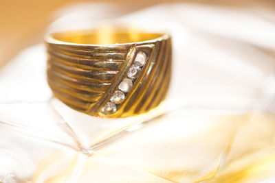 Close-up of gold ring on table