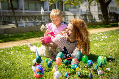 Portrait of smiling family playing with toys at park