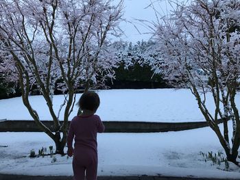Full length of boy on tree against sky