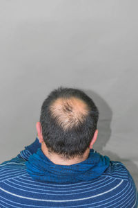 Rear view of man against white background